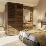 Double Deluxe room with a king-size bed and wooden wardrobe