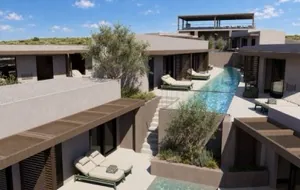 Room terraces with sun loungers stepping down to the shared pool